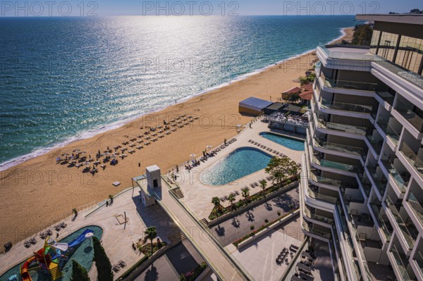 View of a hotel complex with pool on the beach, the Black Sea stretches into the distance, Golden Sands, Varna, Bulgaria, Europe