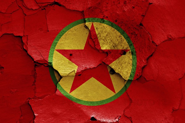 Flag of PKK painted on cracked wall