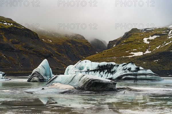 Layers of icebergs against a backdrop of towering mist-covered mountains, iceberg Iceland, glacier, snow, ice rock, ice diamont, glacier lagoon, nature, snow, diamont beach, Iceland, Europe