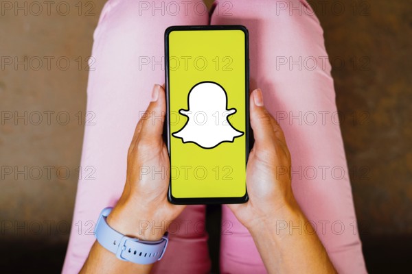In this photo illustration, the Snapchat logo is displayed on a smartphone screen