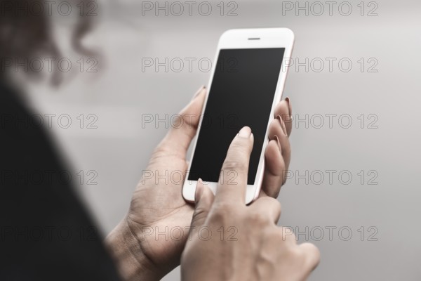 Cropped image of woman's hands holding smart phone with blank copy space screen for your text message or promotional content, female chatting in network on cell telephone