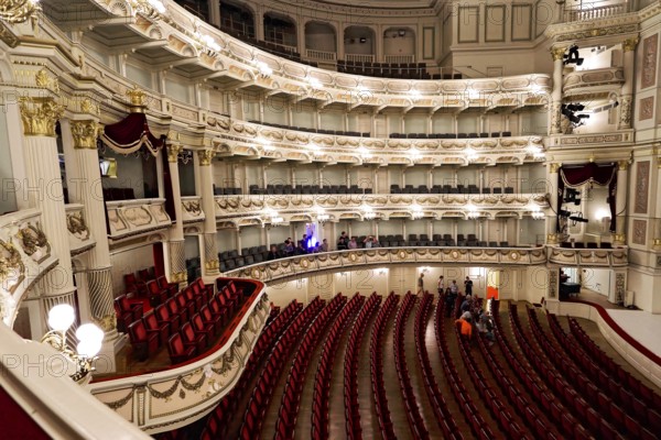 Semperoper, Dresden, Saxony, Germany, Europe, Large opera hall with red empty rows of seats, balconies and a large stage, Europe