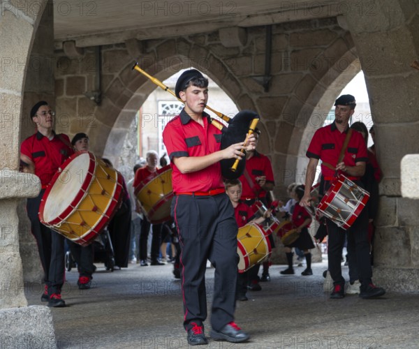 Traditional drum and pipe band perform on city streets on May Day 2025, Guimaraes, Braga district, northern Portugal