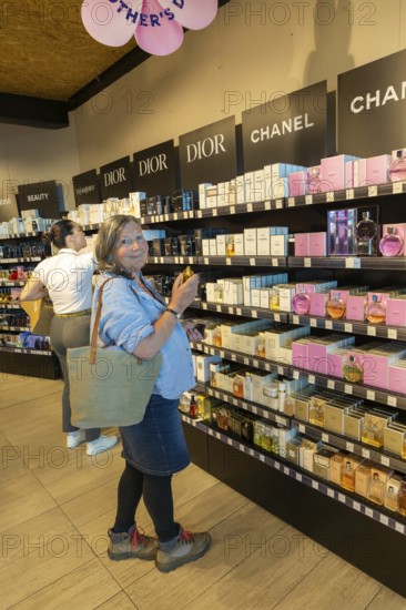 Woman shopping for perfume, Porto Duty Free shops, Aeroporto Francisco Sa Carneiro, Porto airport, Portugal, Europe
