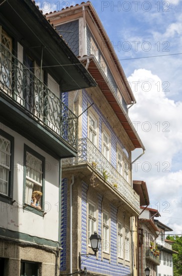 Street of historic buildings with balconies, Rua Egas Montiz, city centre Guimaraes, northern Portugal