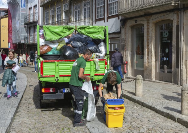 Waste refuse collection service in city centre street, Guimaraes, northern Portugal
