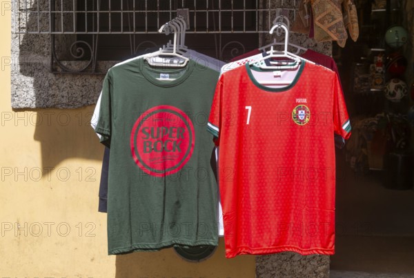 Super Bock brand t-shirt and replica national football shirt on display outside shop, Guimaraes, Portugal, Europe