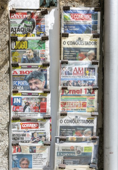 Rack of newspapers on display outside newsagent shop, city of Guimaraes, Portugal, Europe