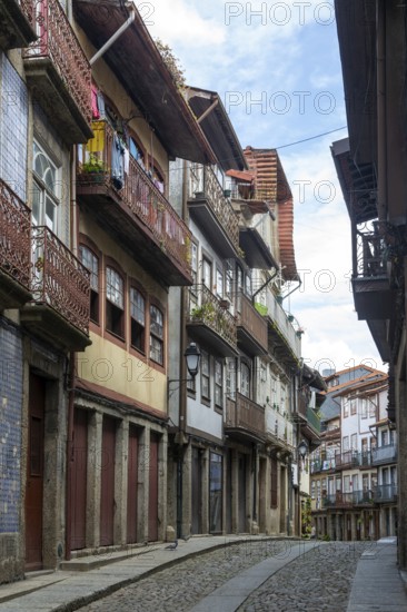 Street of historic buildings with balconies, Rua Egas Montiz, city centre Guimaraes, northern Portugal