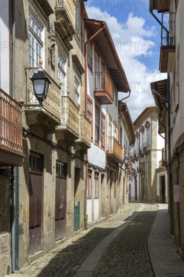 Street of historic buildings with balconies, Rua João Lopes de Faria, city centre Guimaraes, northern Portugal