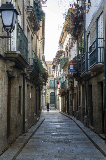 Narrow medieval street Rua de Santa Maria, city centre of Guimaraes, northern Portugal