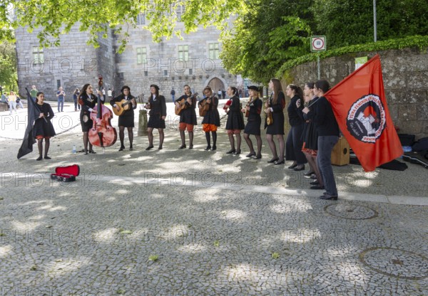 Group female university students musicians perform in street, city of Guimaraes, northern Portugal