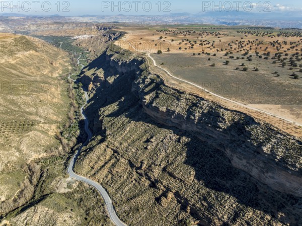 Deep canyon at the Gorafe desert, winding road to village Gorafe, aerial view, Gorafe Desert, UNESCO Granada Geopark, Granada province, Andalusia, Spain, Europe
