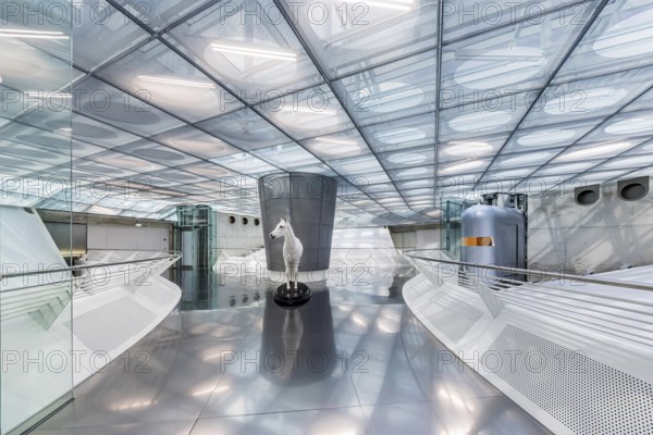 The Mercedes-Benz Museum in Stuttgart presents a journey through the automotive history of the global corporation. The history of the Mercedes star begins with the first automobile in 1886. 160 vehicles are on display. Entrance area with exhibited horse. Stuttgart, Baden-Württemberg, Germany, Europe