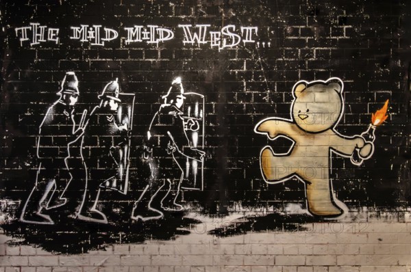Banksy - Mild Mild West, reaction to police crackdown on unlicensed rave parties, 1999, Stokes Croft, Bristol, UK, exhibition The World of Banksy