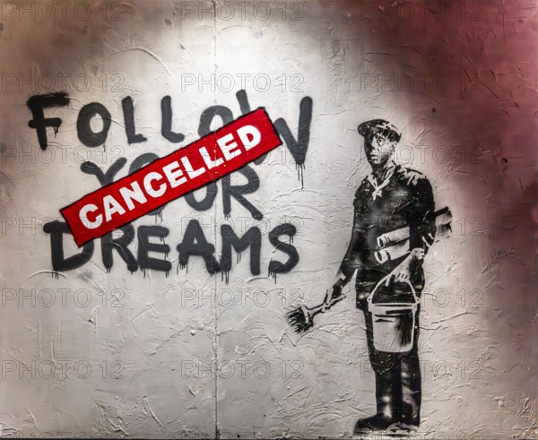 Banksy - Follow Your Dreams, exhausted-looking worker, 2010, Chinatown, Boston, USA, exhibition The World of Banksy, North America