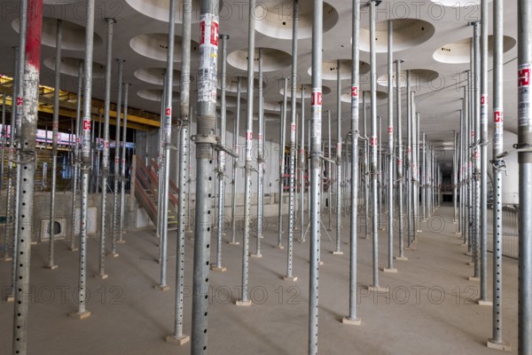 Rows of scaffolding in an unfinished interior with perforated ceiling, supports, construction site of the new Stuttgart 21 railway station, Stuttgart, Baden-Württemberg, Germany, Europe