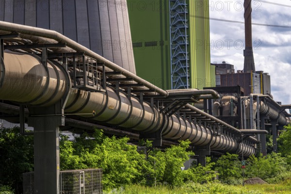 Pipelines for various gases, blast furnace gas, Thyssenkrupp Steel steelworks in Duisburg-Bruckhausen, in front the gas-fired Hamborn power station, green façade of boiler house Block5, North Rhine-Westphalia, Germany, Europe