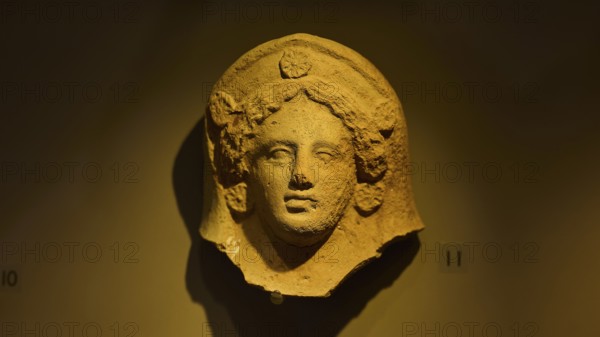 Ancient stone head of a goddess, exhibited in a museum-like setting, found in the cave of Aspri Petra, Archaeological Museum, Kos Town, Kos, Dodecanese, Greek Islands, Greece, Europe