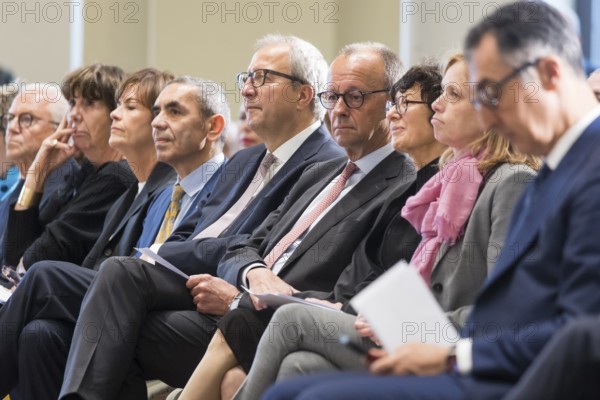 Ugur Sahin (founder of Biontech SE), Andreas Voßkuhle (President of the Senate of the German National Foundation), Friedrich Merz (Chancellor of the Federal Republic of Germany) and Özlem Türeci (founder of Biontech SE) at the award ceremony for the German National Prize 2025 in the Französische Friedrichstadtkirche, Berlin, on 10 June 2025