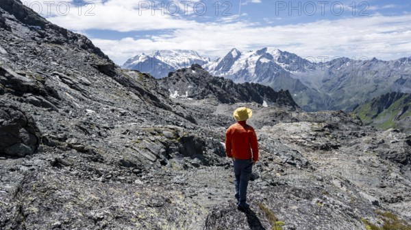 Mountaineer in rocky mountain landscape at the Col du Louvie, view of the summit of the Grand Combine, Valais Alps, Val de Bagnes, Valais, Switzerland, Europe