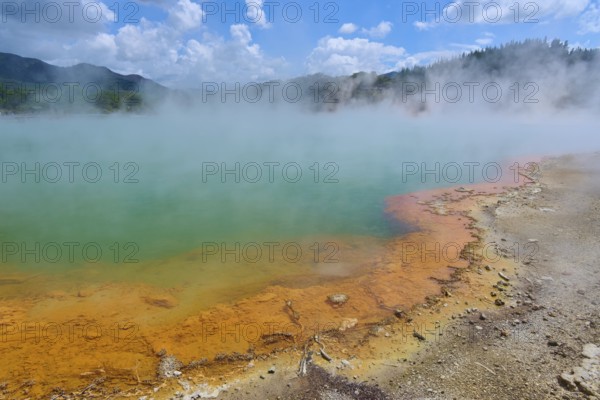A hot spring with coloured rocks and steaming water, Champagne Pool thermal lake, Wai-O-Tapu Thermal Wonderland, Rotorua, North Island, New Zealand, Oceania