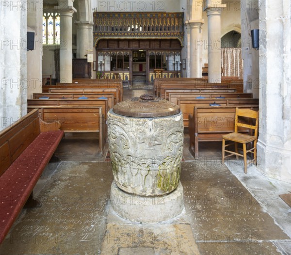 Historic baptismal font inside village parish church of Saint James, Avebury, Wiltshire, England, UK