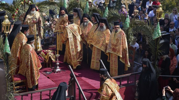 Priests in golden robes stand on a stage during a religious ceremony, surrounded by a large crowd, Orthodox ceremony, monks of St John's Monastery, ceremonial washing of feet, procession, Maundy Thursday, Megali Pempti, Chora, Patmos, Dodecanese, Greek Islands, Greece, Europe