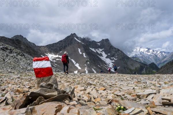 Red and white trail markings, hiker in the high mountains, Lasörling High Trail, Lasörling High Trail, Austria, Europe