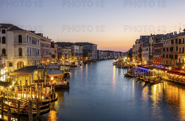 View of the Grand Canal at the blue hour, picturesque evening mood with illuminated palazzos on the canal, long exposure, view from the Rialto Bridge, Venice, Veneto, Italy, Europe