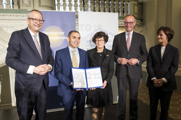 Thomas Mirow (Chairman of the Board of the German National Foundation), Ugur Sahin and Özlem Türeci (founders of Biontech SE), Friedrich Merz (Chancellor of the Federal Republic of Germany) and Nicola Leibinger-Kammüller (member of the Board of Trustees of the German National Foundation) at the award ceremony for the German National Prize 2025 in the Französische Friedrichstadtkirche, Berlin, on 10 June 2025