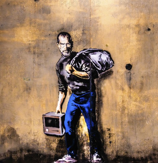 Banksy - Steve Jobs as a Syrian refugee in a refugee camp, 2015, The Jungle Refugee Camp, Calais, France Exhibition The World of Banksy