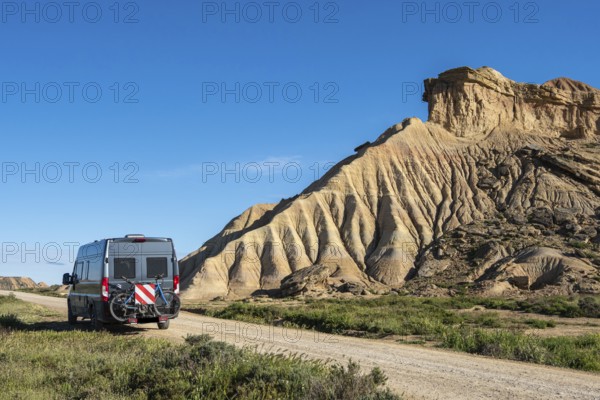 Colorful rock formation, camper van, semi-desert, Bardena Blanca area, Bardenas Reales Nature Park, Navarre, Spain, Europe