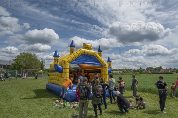 Children's fun, bouncy castle and football games in a meadow during the baking oven festival, Kleingeschaidt, Middle Franconia, Bavaria, Germany, Europe