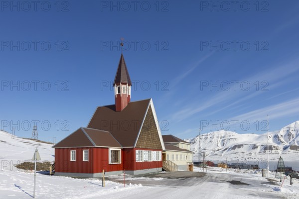 1958 red wooden Evangelical Lutheran Svalbard Church in the town Longyearbyen in winter, Spitsbergen, Norway, Europe