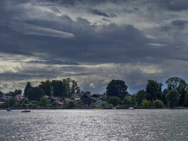 Dark clouds over Lake Chiemsee, view of the island of Frauenchiemsee, Bavaria, Germany, Europe