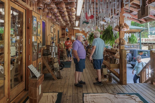 Senior men on the front porch of Bearmeats Indian Den arts, crafts and souvenir shop in Cherokee, North Carolina
