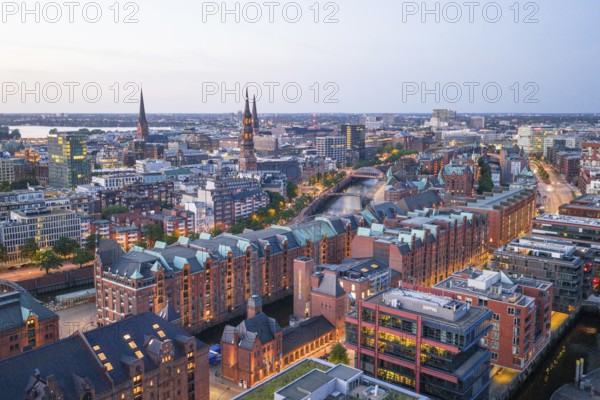 Aerial view of the Speicherstadt Hamburg at blue hour with churches and Alster in the background, Hamburg, Germany, Europe
