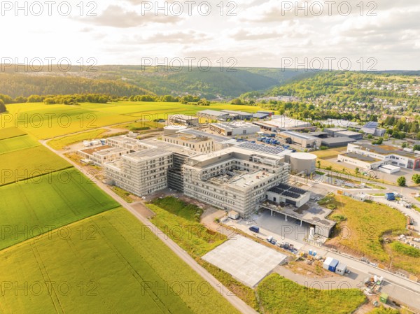 Modern building complexes next to green fields and a picturesque landscape, construction of the new hospital health campus Calw, Germany, Europe