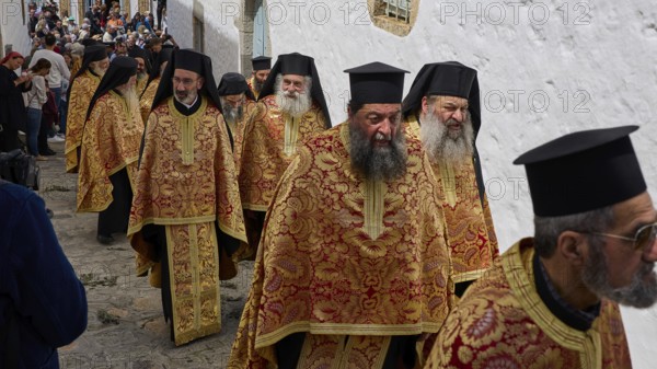 A group of priests in traditional gold and red robes walk during a procession, Orthodox ceremony, monks of St John's Monastery, ceremonial washing of feet, procession, Maundy Thursday, Megali Pempti, Chora, Patmos, Dodecanese, Greek Islands, Greece, Europe