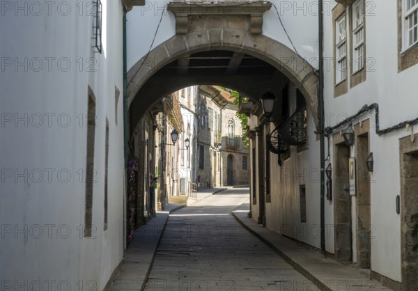 Narrow medieval street Rua de Santa Maria, city centre of Guimaraes, northern Portugal