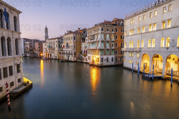 View of the Grand Canal at sunset, picturesque evening mood with illuminated palazzos on the canal and the church tower of the Chiesa Parrocchiale dei Santi Apostoli, long exposure, view from the Rialto Bridge, Venice, Veneto, Italy, Europe