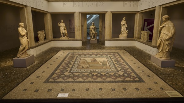 A room in a museum with several ancient sculptures and a decorated floor mosaic, Roman House of Asklepios in Serayia, Scene: Asklepios lands on Kos, Archaeological Museum, Kos Town, Kos, Dodecanese, Greek Islands, Greece, Europe