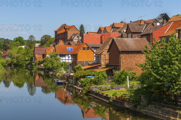 Old fishermen's settlement along the Werra, Bad Sooden, Allendorf, district Allendorf, street Fischerstad under monument protection, half-timbered houses, water reflection, trees, garden, sports boat, blue sky, Werra-Meissner-Kreis, Hesse, Germany, Europe