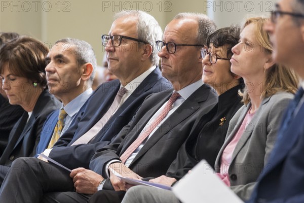 Ugur Sahin (founder of Biontech SE), Andreas Voßkuhle (President of the Senate of the German National Foundation), Friedrich Merz (Chancellor of the Federal Republic of Germany) and Özlem Türeci (founder of Biontech SE) at the award ceremony for the German National Prize 2025 in the Französische Friedrichstadtkirche, Berlin, on 10 June 2025