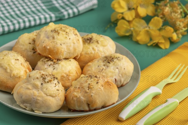Baked pizza, balls on a plate with decoration and cutlery
