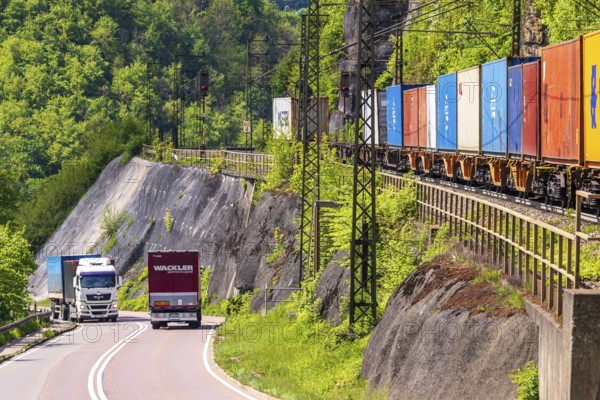 Goods train travelling on the winding Geislinger Steige railway line. Landscape along the railway line in spring. Amstetten, Baden-Württemberg, Germany, Europe
