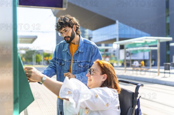 Woman in a wheelchair validating her ticket at a modern tram stop, with a friend providing assistance and support during the process