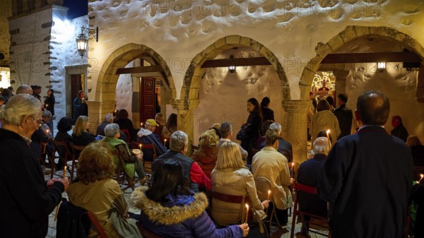 Good Friday, Church of Agios Ioannis Prodromos, worshippers, gathering of people with candles in front of a traditional building at night, Skala, harbour, Patmos, Dodecanese, Greek Islands, Greece, Europe
