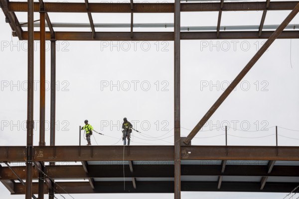 Detroit, Michigan - Workers string safety lines as structural steel rises on a $2.2 billion expansion of Henry Ford Hospital's main campus. Completion is expected in 2029